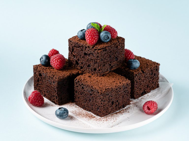 Chocolate,Brownie,Squares,Stacked,On,White,Ceramic,Plate,Decorated,With