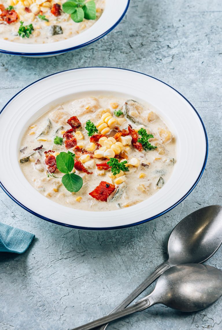 Creamy,Corn,,Zucchini,And,Bacon,Chowder,On,Blue,Stone,Background