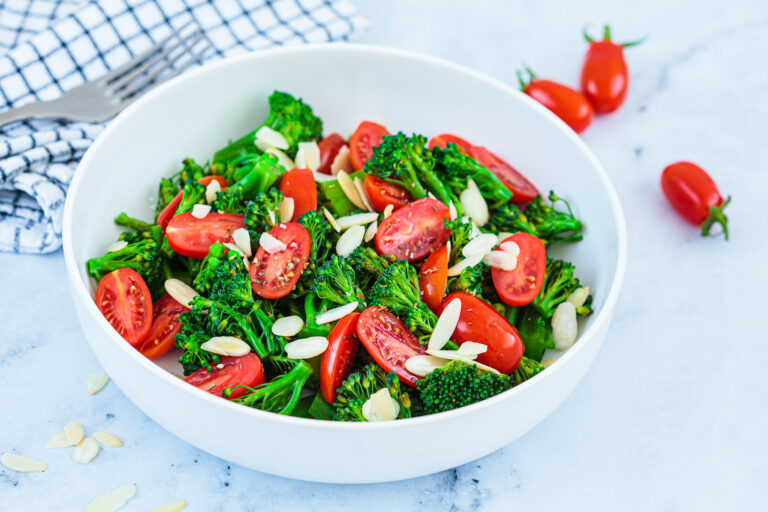 Broccoli,Salad,With,Cherry,Tomatoes,And,Almonds,In,A,White