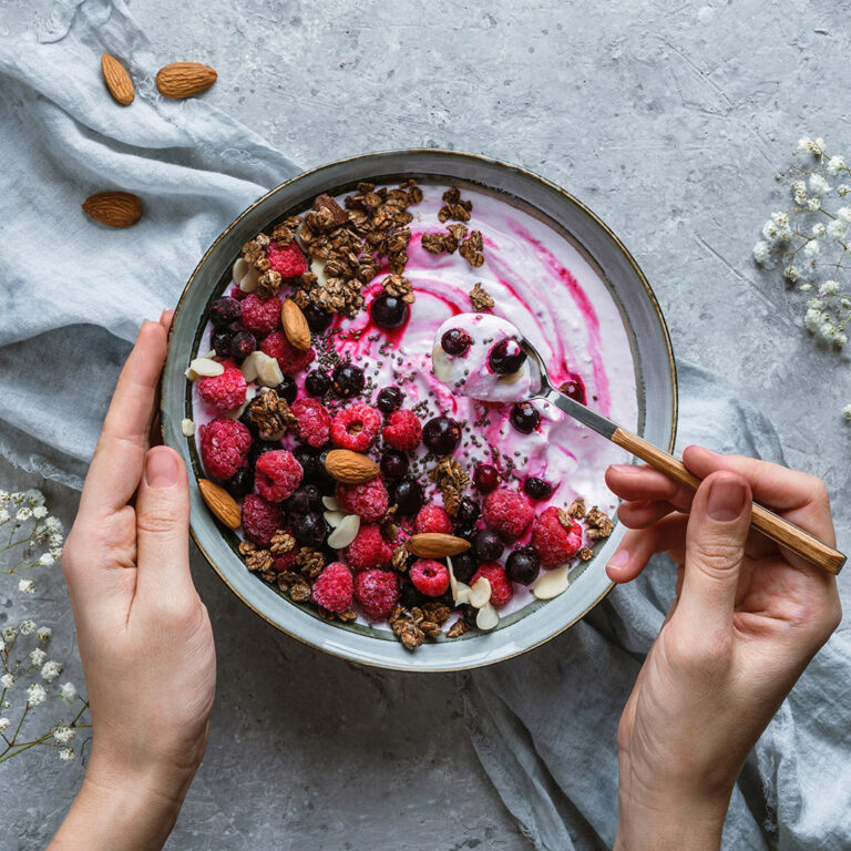 Hands,Holding,A,Bowl,Of,Natural,Yogurt,With,Oat,Granola,