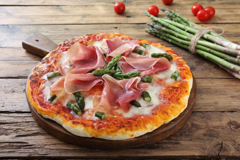 Italian,Pizza,With,Ham,And,Asparagus,On,Rustic,Table,Background