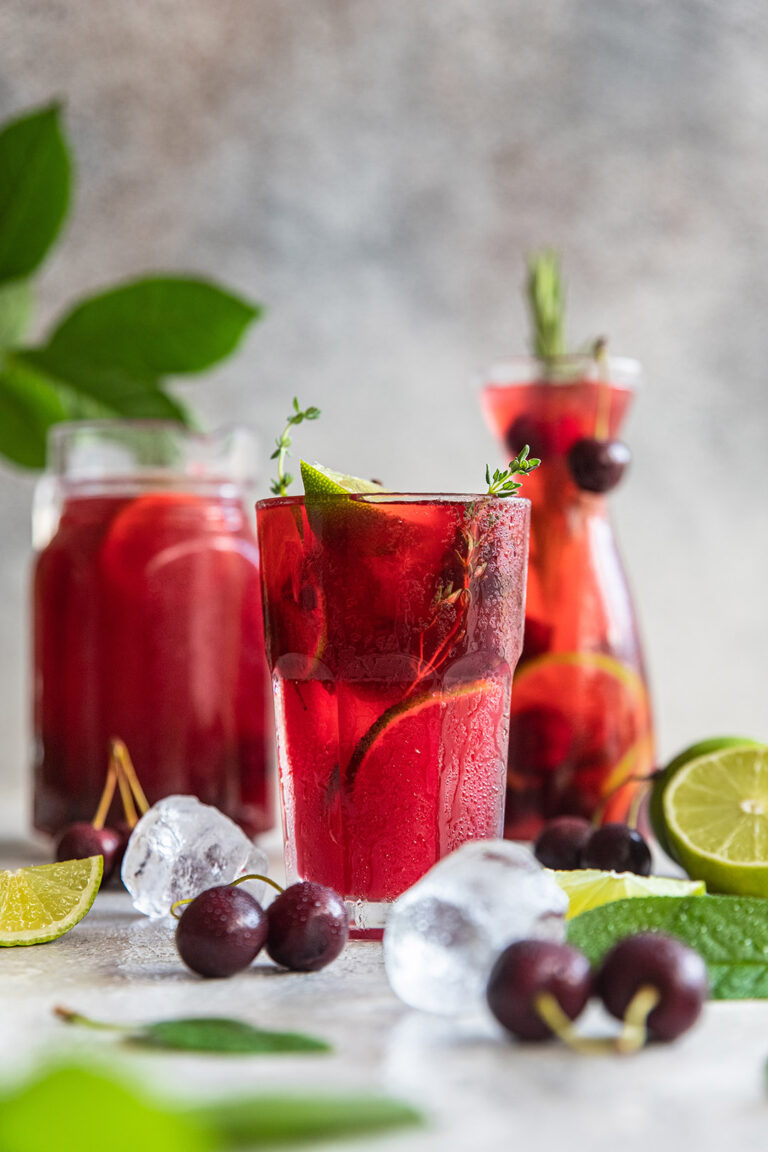 Cocktail,Or,Lemonade,With,Cherries,And,Lime,,Grey,Stone,Background