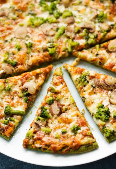Spinach base pizza with broccoli, mozzarella and mushrooms