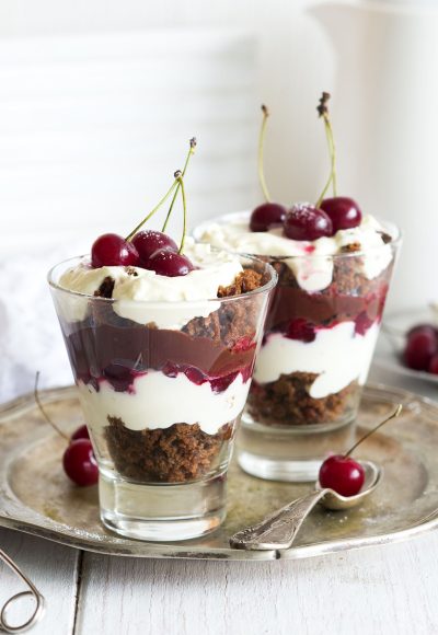 Beautiful festive dessert Black forest trifle with chocolate sponge and vanilla cream