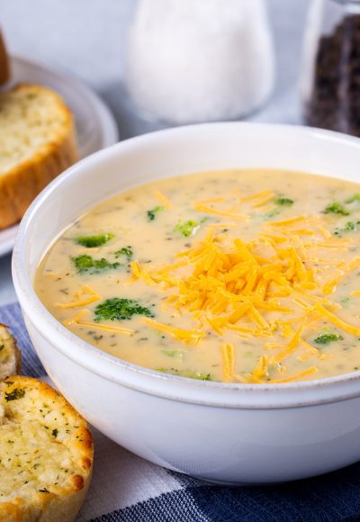 Bowl of creamy broccoli cheddar cheese soup with toasted cheese bread