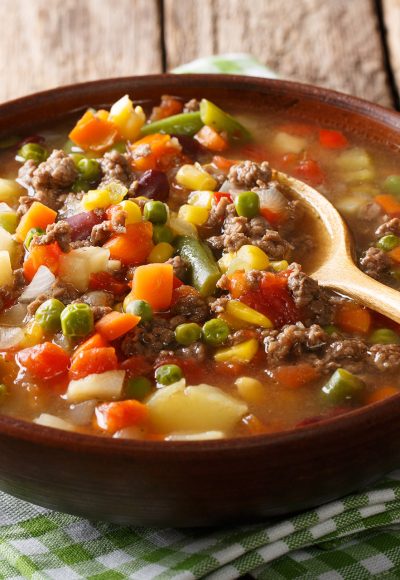 Tomato soup with ground beef and vegetables close-up in a bowl on the table. horizontal