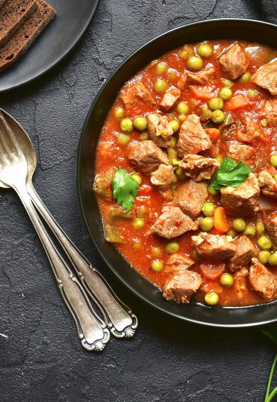 Veal stewed with vegetables in tomato sauce.