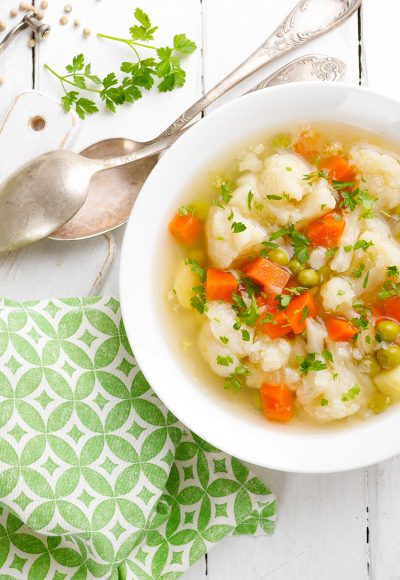 Vegetable soup with cauliflower, carrot, green peas, onion and potato