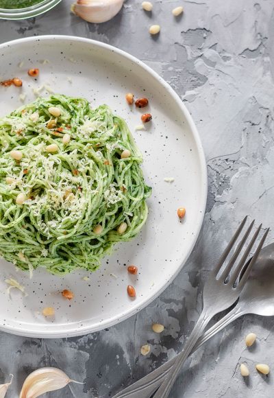 Green vegan pasta with avocado, spinach and pine nuts. Healthy and wholesome food. Good nutrition.