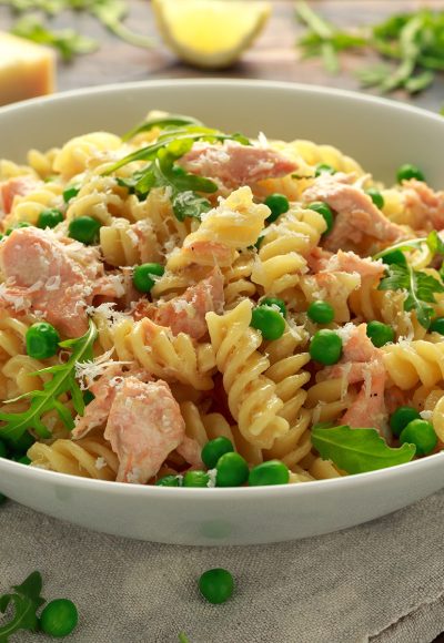 Homemade Pasta fusilli with salmon, green peas, parmesan cheese and lemon. healthy food