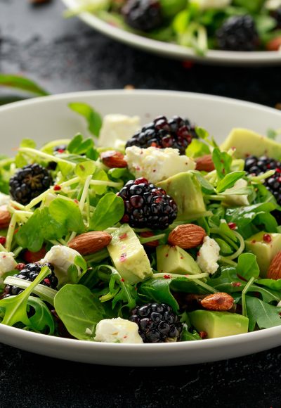 Blackberry salad with greens, almond nuts, feta, avocado and feta cheese