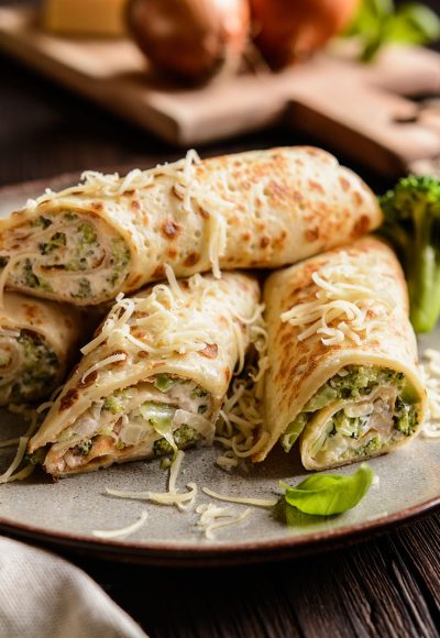 Salty pancakes stuffed with broccoli, sour cream, cheese and onion