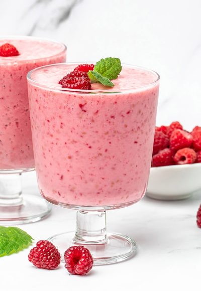 raspberries smoothie in glass jar with berries. Yogurt cocktail on a light background. Natural detox. Long banner format.