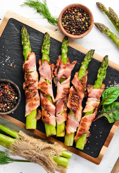 Asparagus baked with bacon and spices. Healthy food. Top view. Free space for your text.